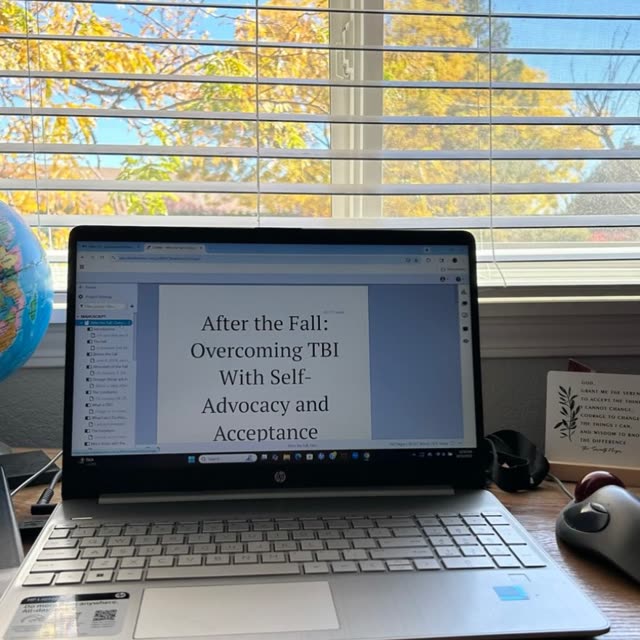 Her laptop on her desk by a window of autumn leaves, open to the manuscript of After the Fall