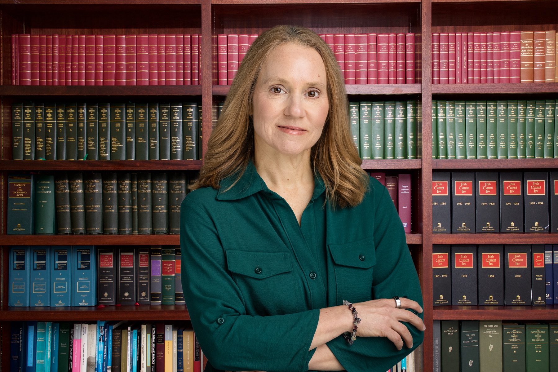 Stacey Hamilton in front of her bookshelves